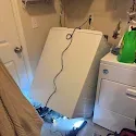 Customer-uploaded photo of a washing machine repair visit